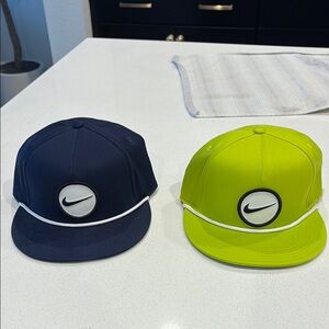 Two (2) Nike Golf  Navy and Cyber Green Snapbacks.